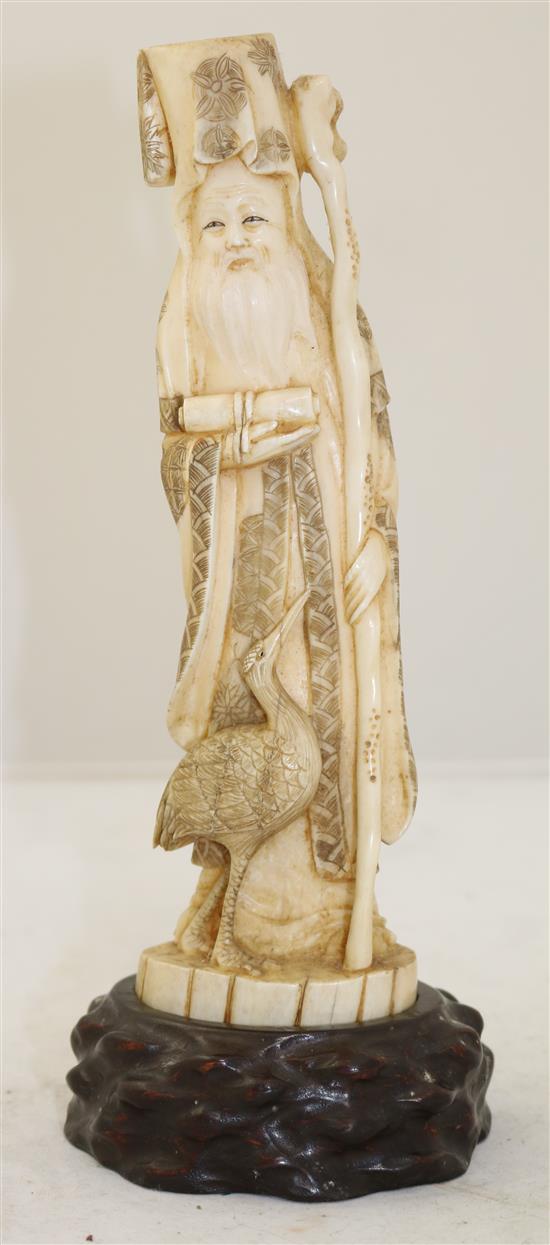 A Japanese walrus ivory figure of Fukurokuju, early 20th century, height 24.5cm incl. wood stand